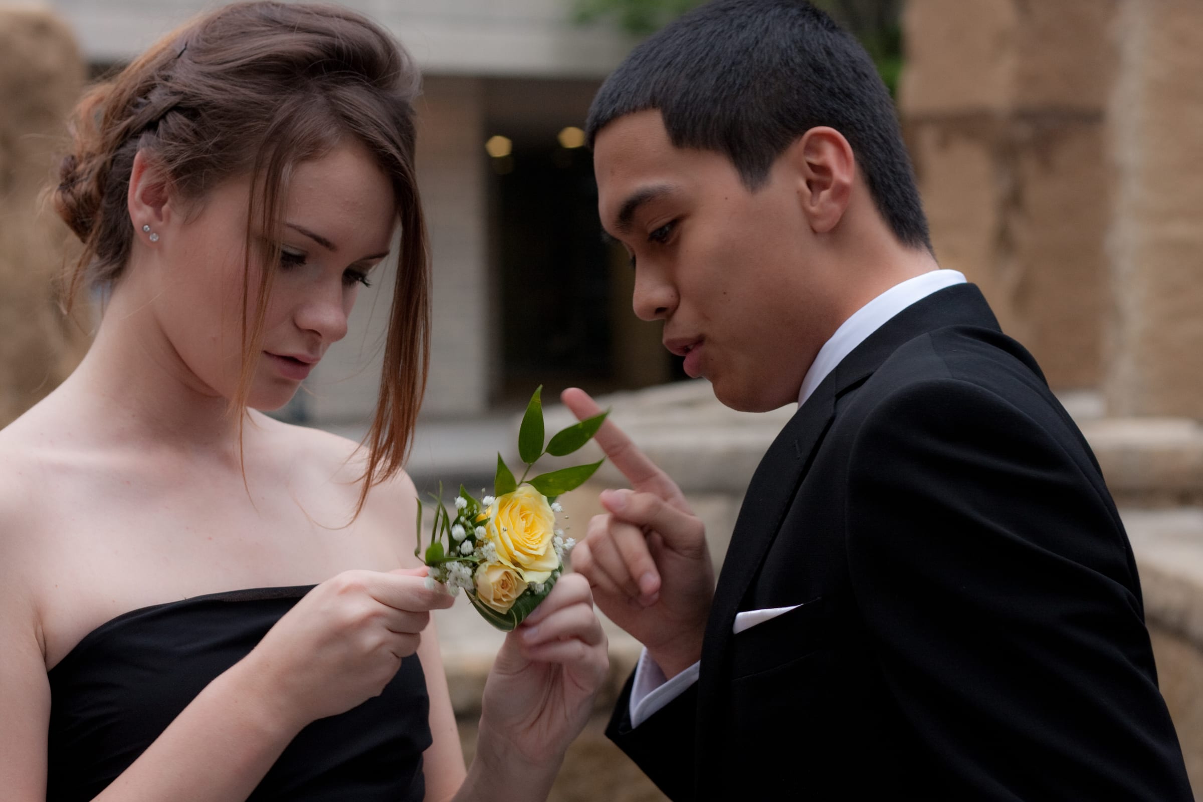 Couple sharing a quiet moment while examining a flower