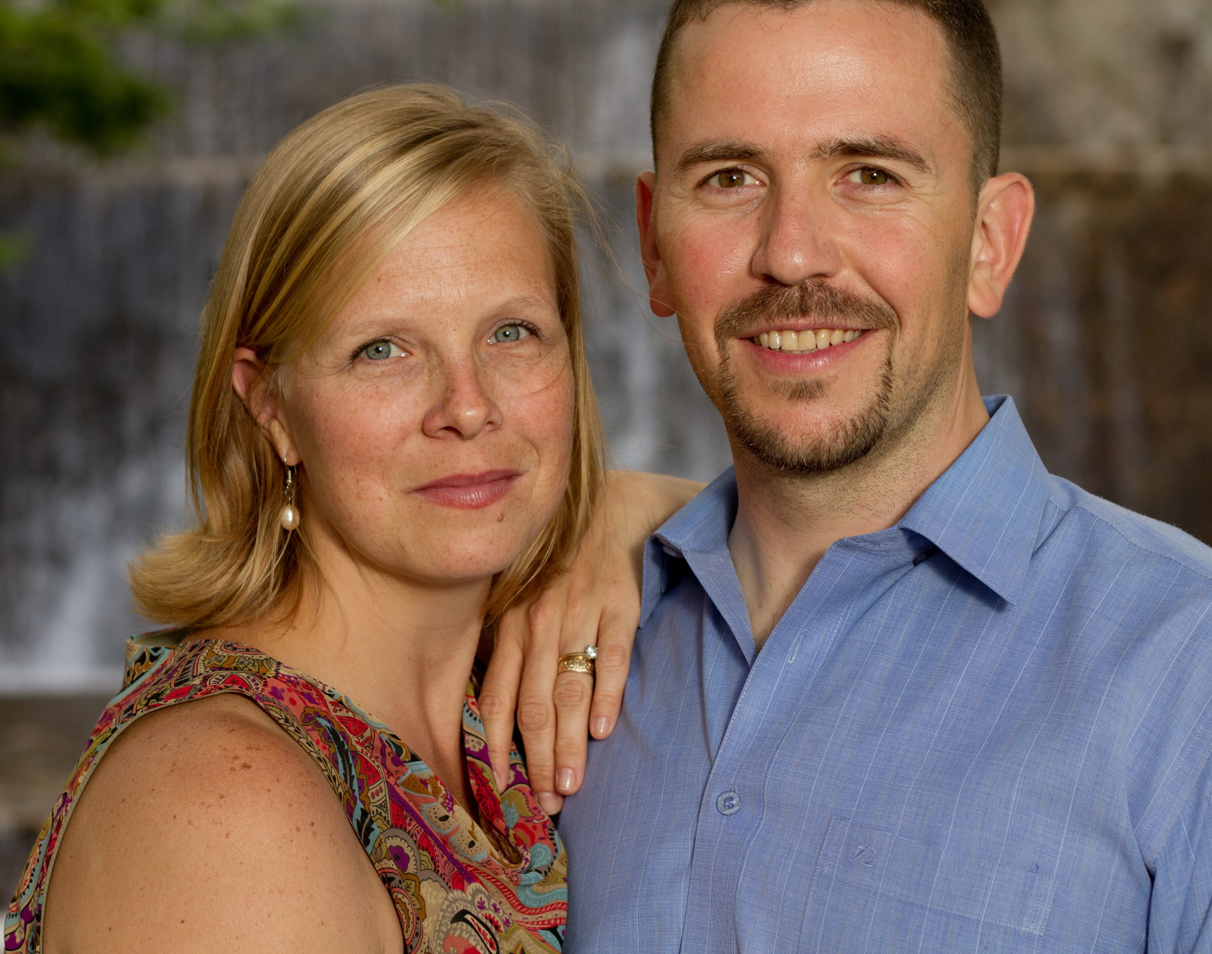 Couple portrait beside a waterfall