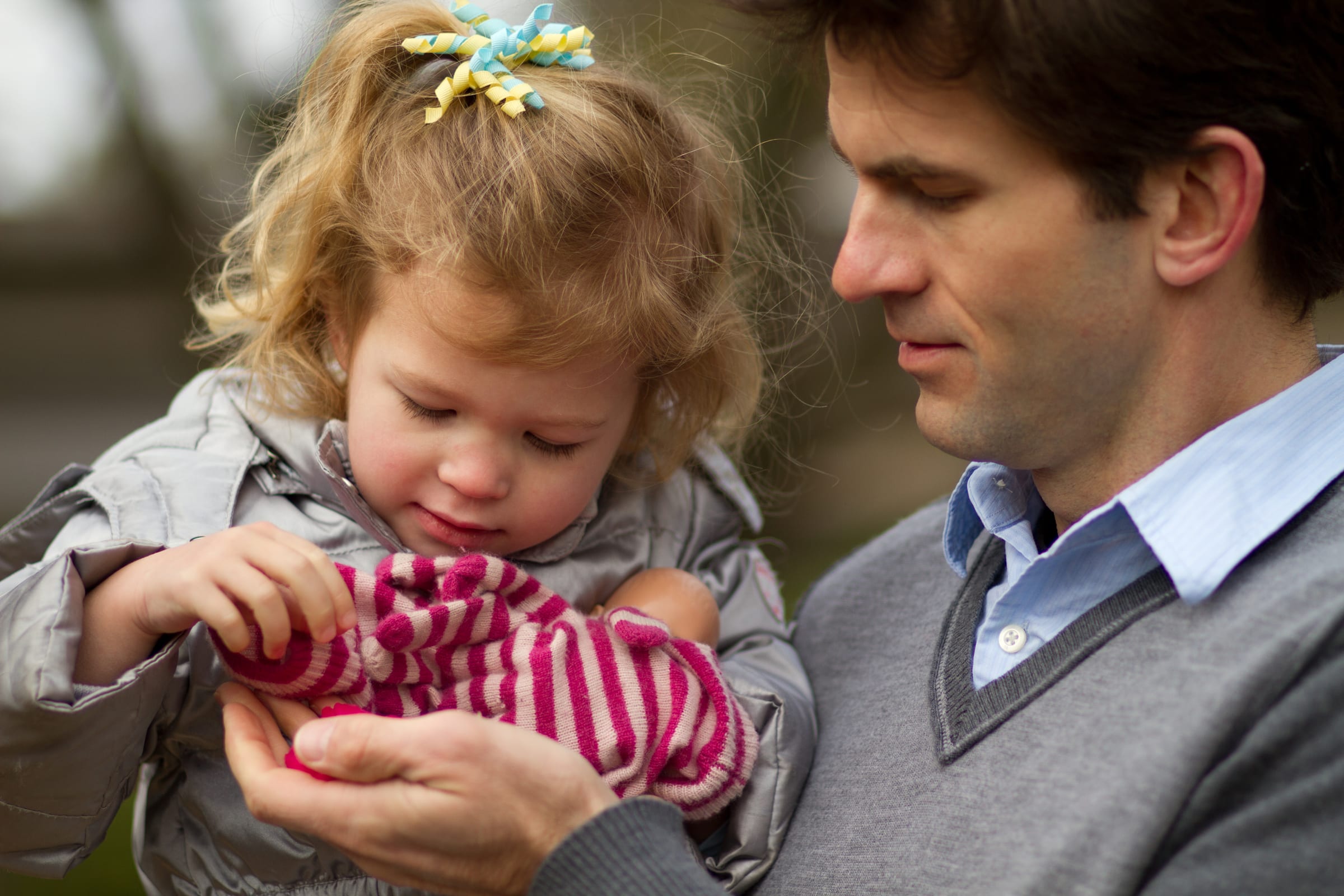 Father holding young child in a quiet candid moment