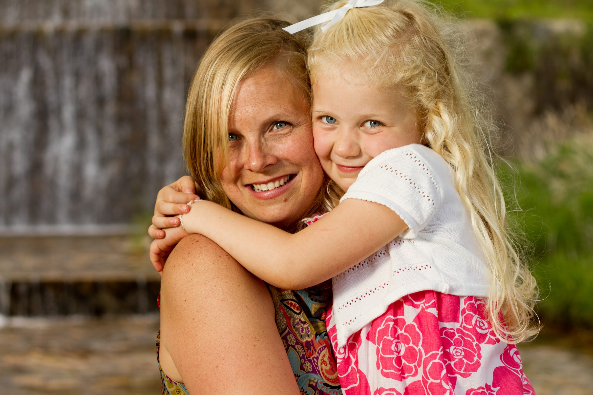 Mother and daughter embracing outdoors