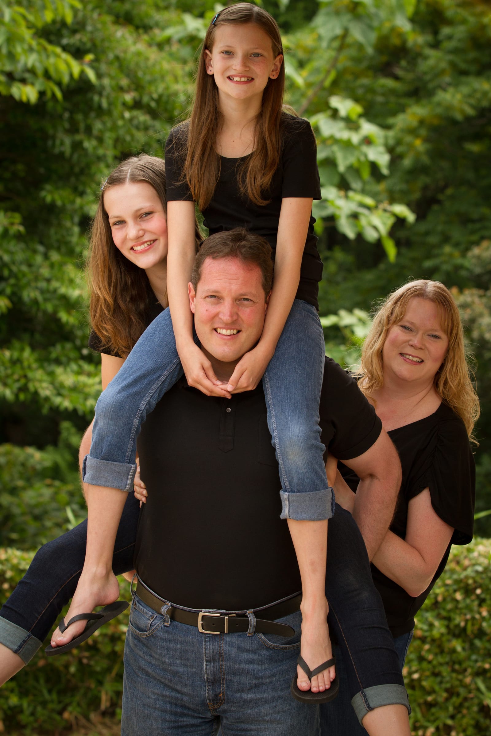 Playful stacked family portrait outdoors